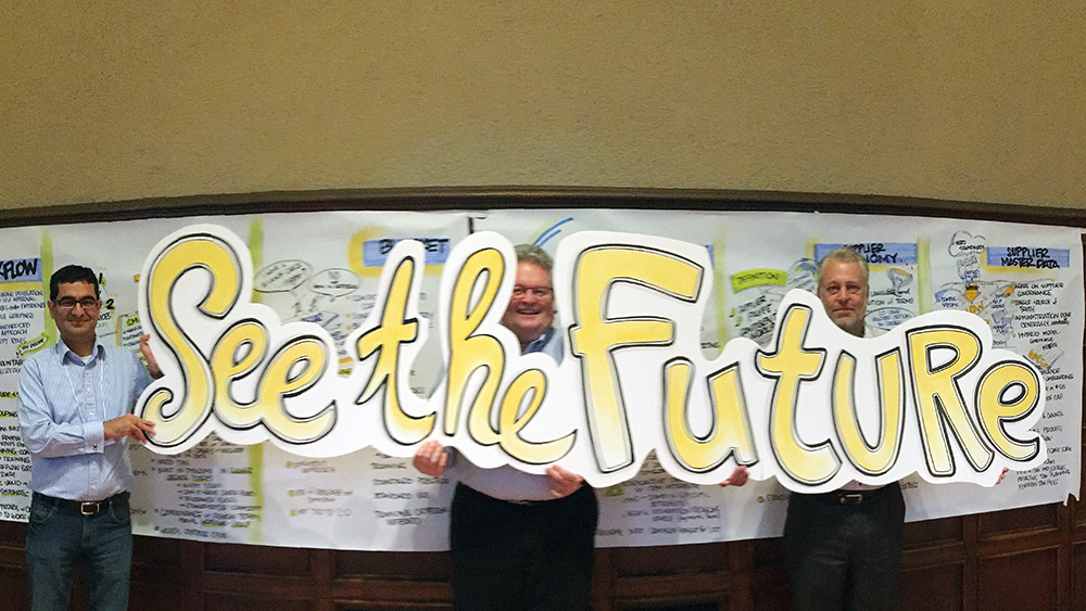 See the Future graphic held by three corporate team member after graphic facilitation session